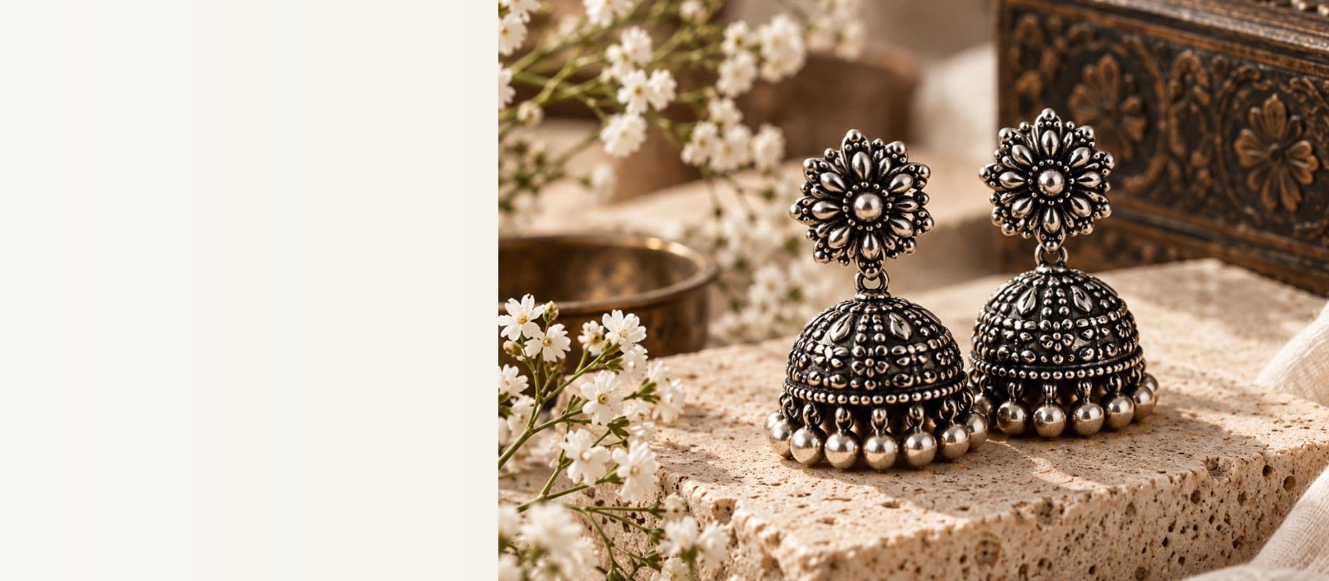 Authentic handcrafted oxidised 925 sterling silver jhumkas on warm travertine stone